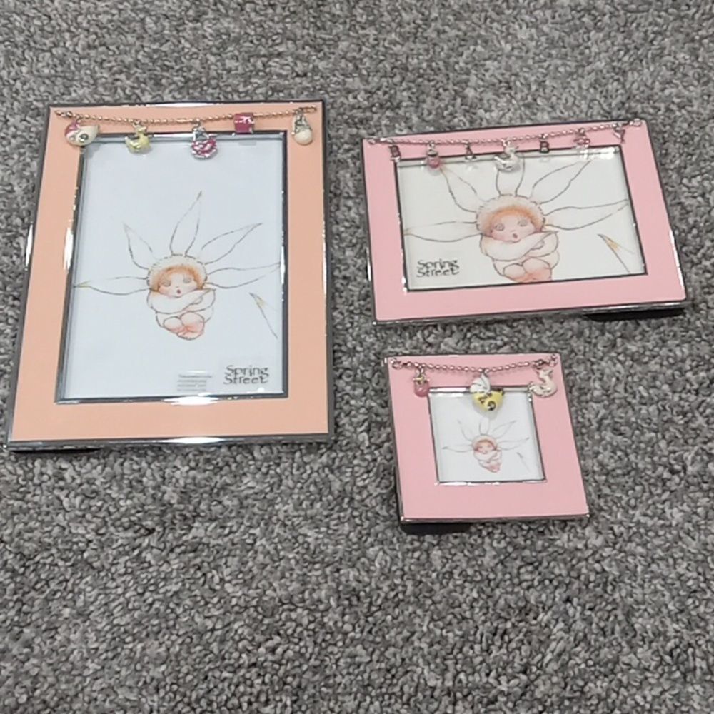 Set of 3 Spring Street picture frames w charms. 2 are pink & silver 1 is peach.
